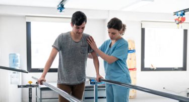 Nurse with patient during physical therapy